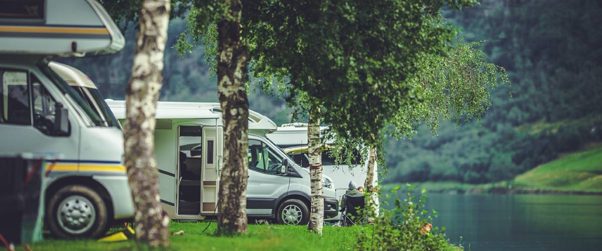 Campervans-and-Motorhome-pitched-by-a-lake Campervans and motorhomes pitched by a lake