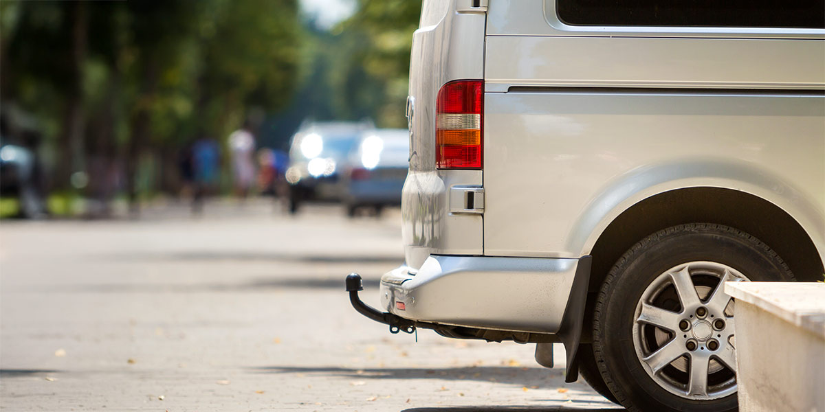 Silver campervan with a tow bar attached on the back