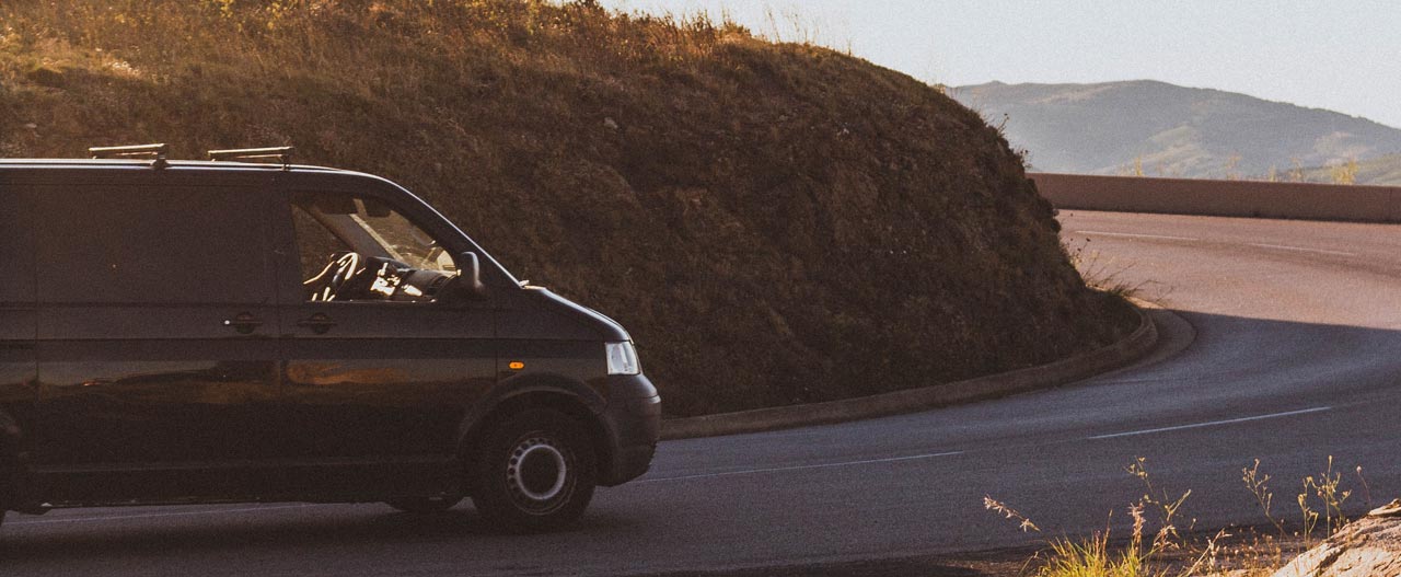 VW T5 driving on a scenic road