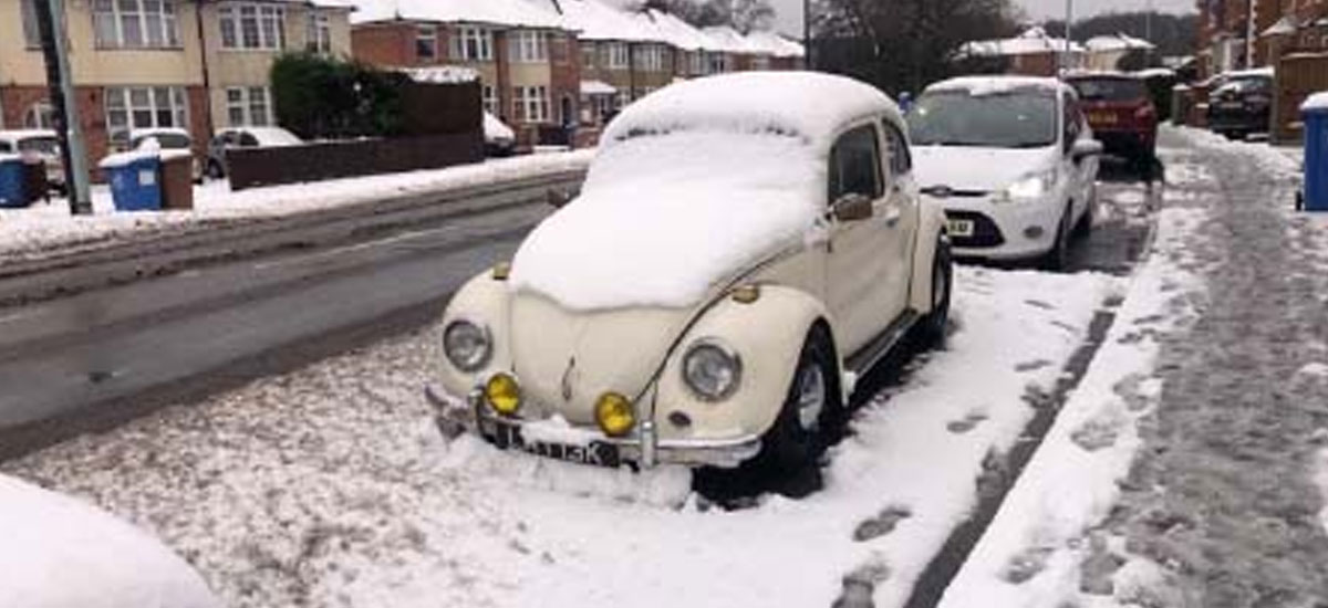 Earl, the white Beetle parked up on a street in the snow