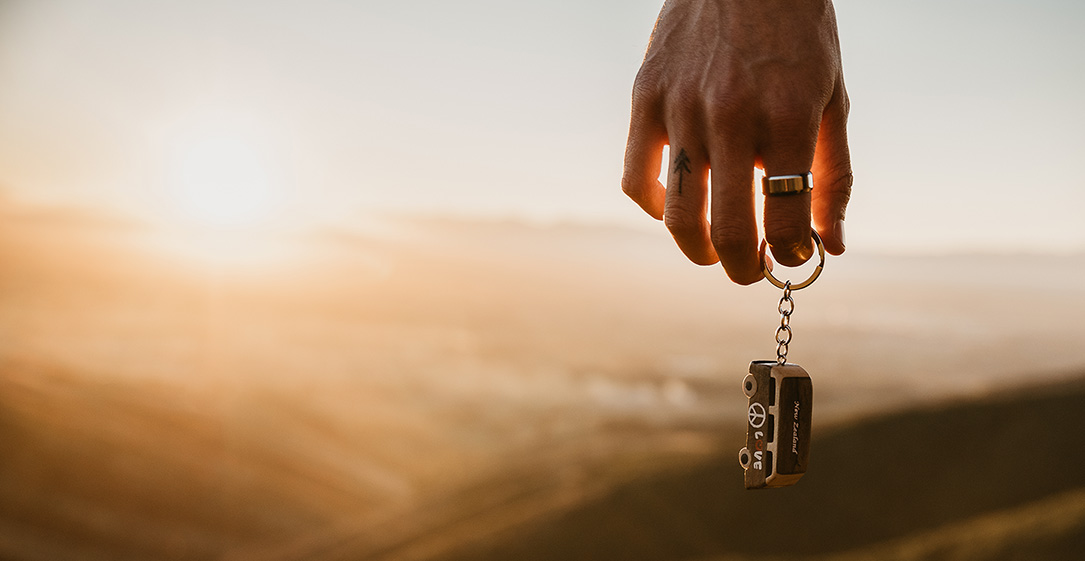 Hand,Holding,A,Keyring,To,A,Campervan Tents with horses in a field (1)