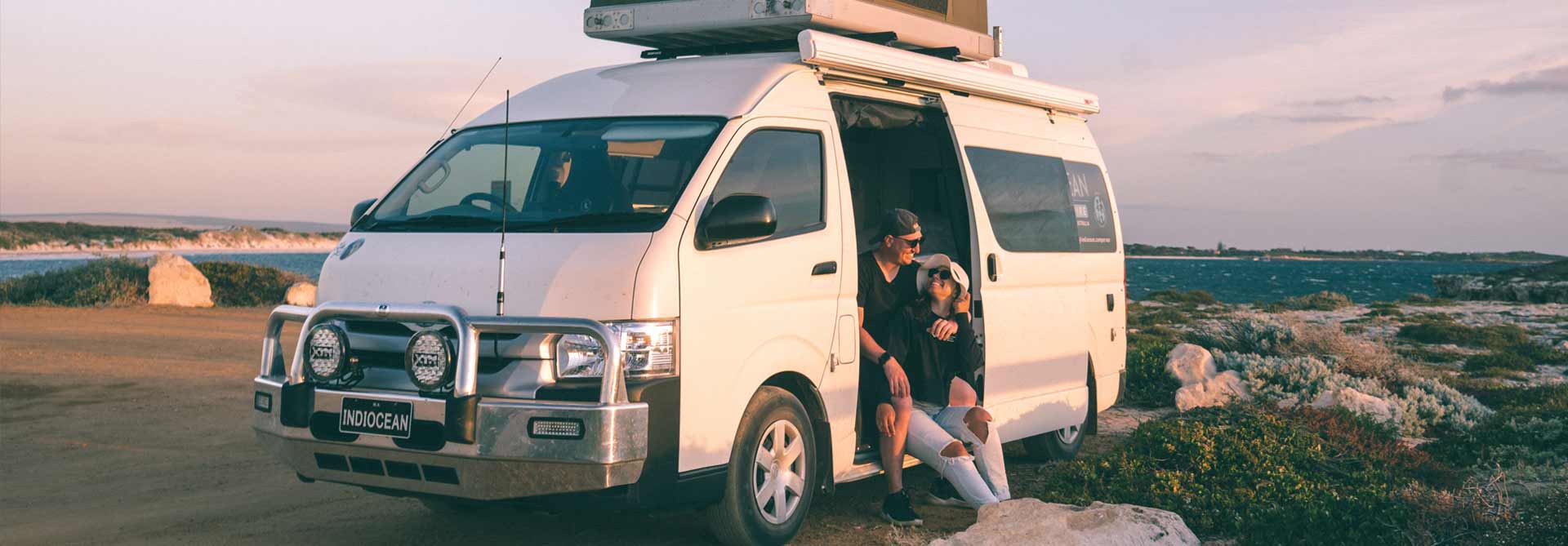 A campervan parked on a coastal road