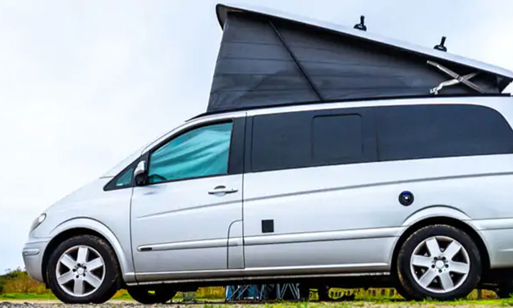 JKI25-Mercedes-Vito-Image-Header-1 A silver Mercedes Vito camper van with the pop-up roof elevated