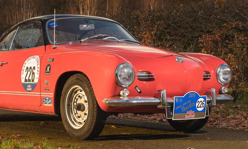 JKI25-VW-Karmann-Ghia-Insurance-Header-1 A red and black VW Karmann Ghia with racing numbers on the side doors