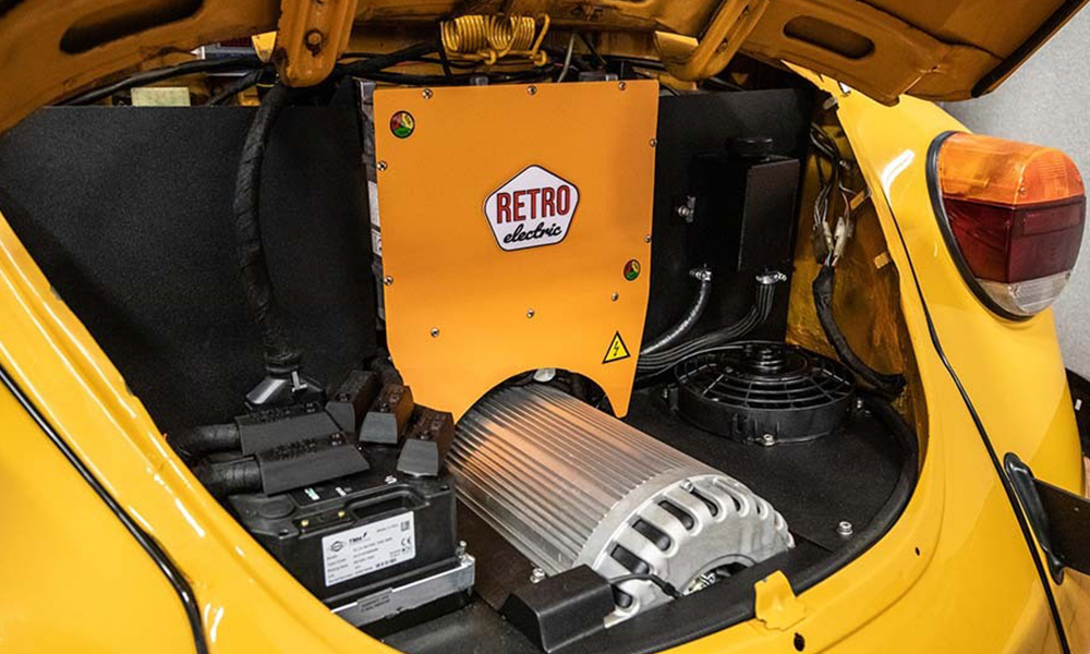 Classic EV Image Electric Beetle for Just Kampers Insurance An electric motor installed in the back of a yellow classic VW Beetle