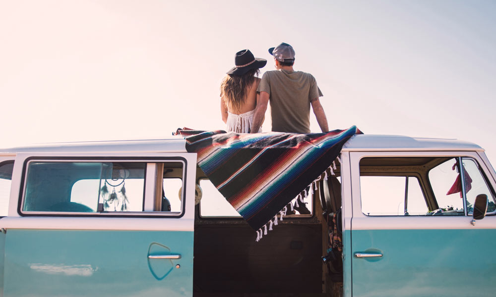 JKI25-Contact-Us-Just-Kampers-Header-1 A couple sat on top of a classic VW Campervan
