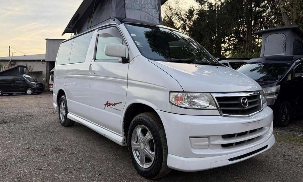 JKI25-Mazda-Bongo2-Insurance-Header-1 A white Mazda Bongo with the elevated roof extended