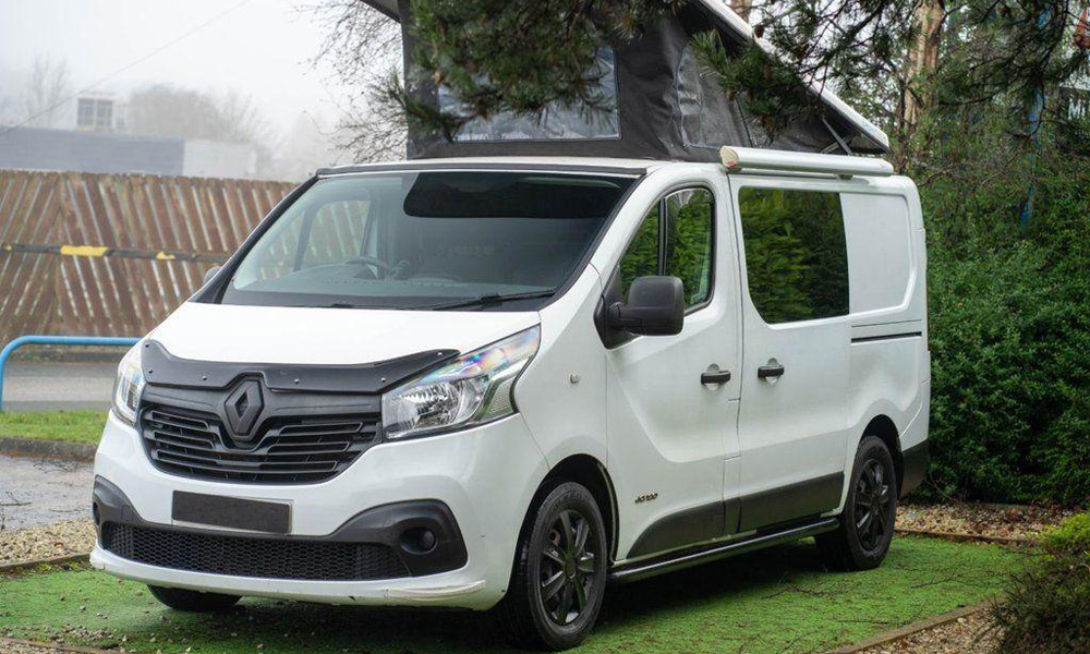 Renault-Trafic-Header-Image-for-Just-Kampers-Insurance A white Renault Trafic with it's elevating roof extended