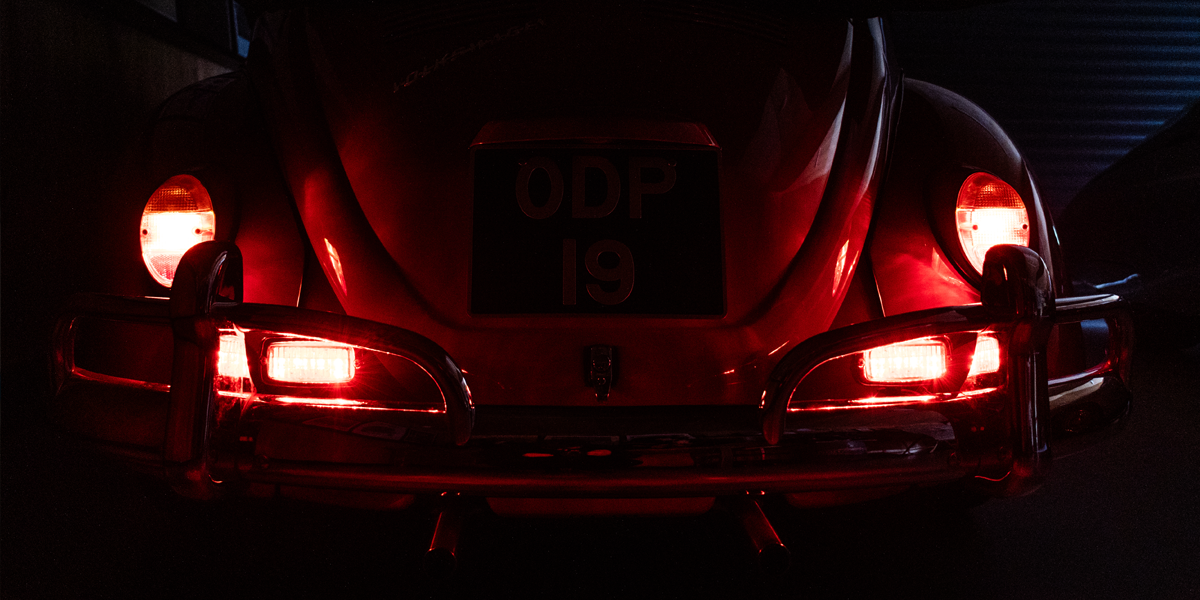 The LED Rear Light Upgrade units created by our sister company, Just Kampers, shining brightly on the back of a classic VW Beetle
