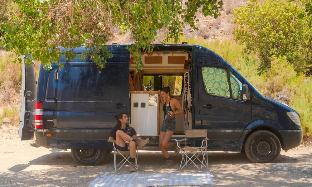 A young couple with their converted camper van