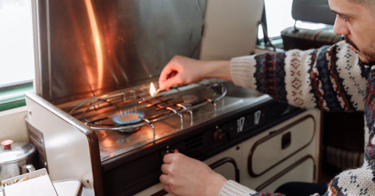 Man lighting a campervan cooker