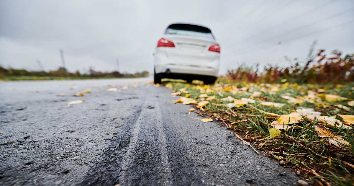 White car at the side of the road