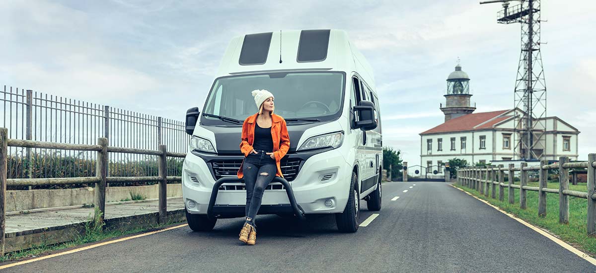 Woman leaning on a campervan