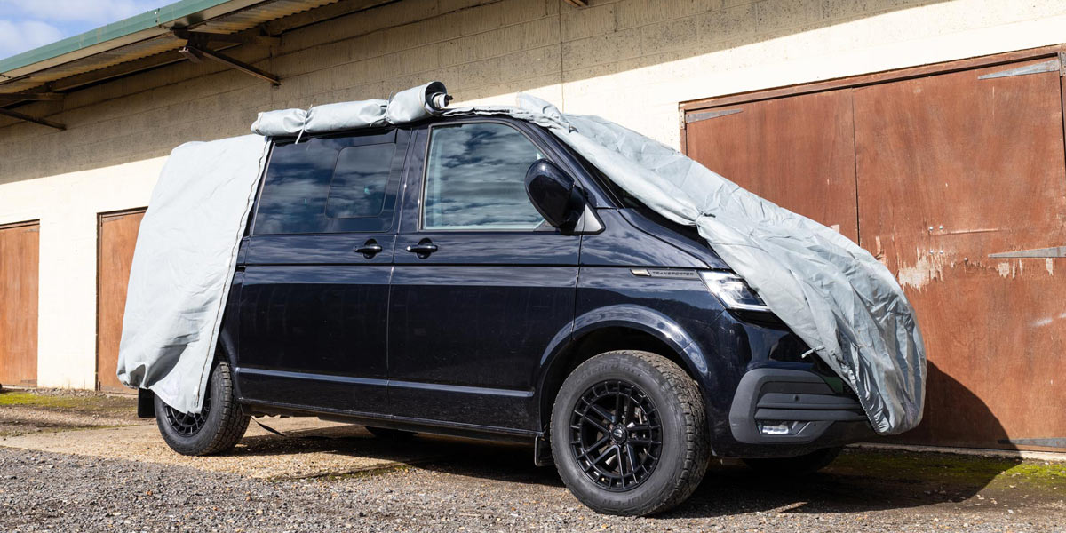 A VW T6 with a breathable vehicle cover from Just Kampers fitted to it