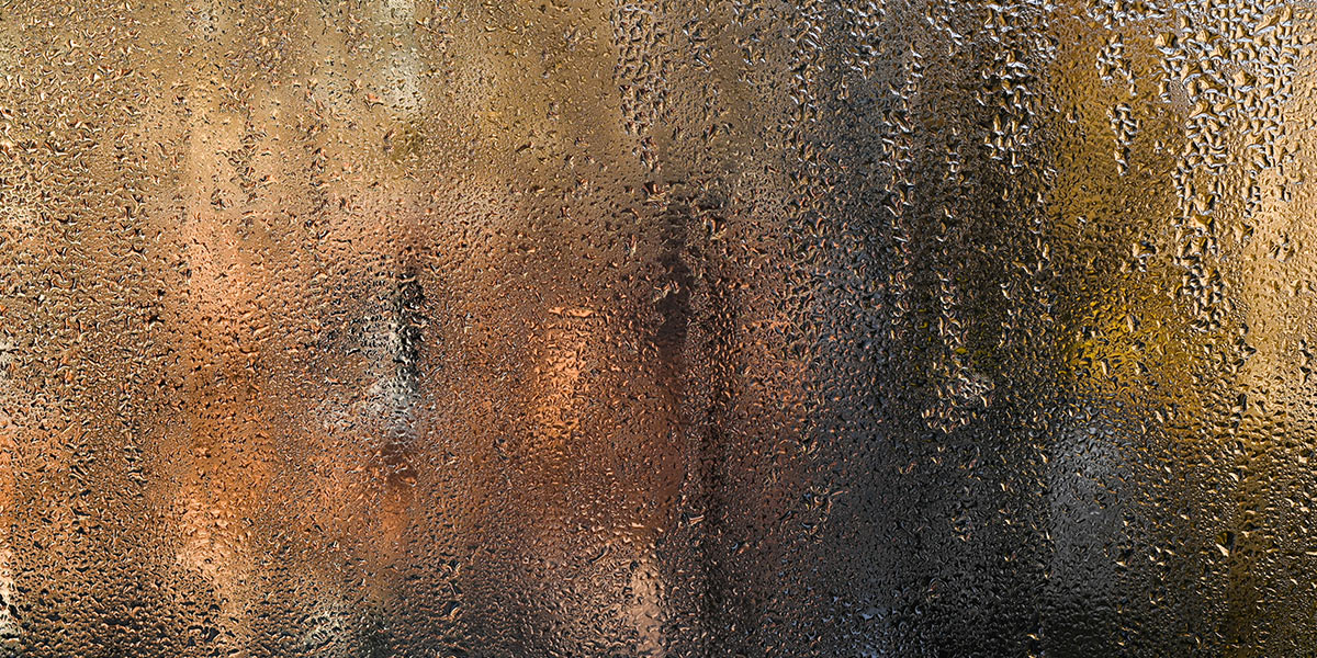 A glass window with condensation