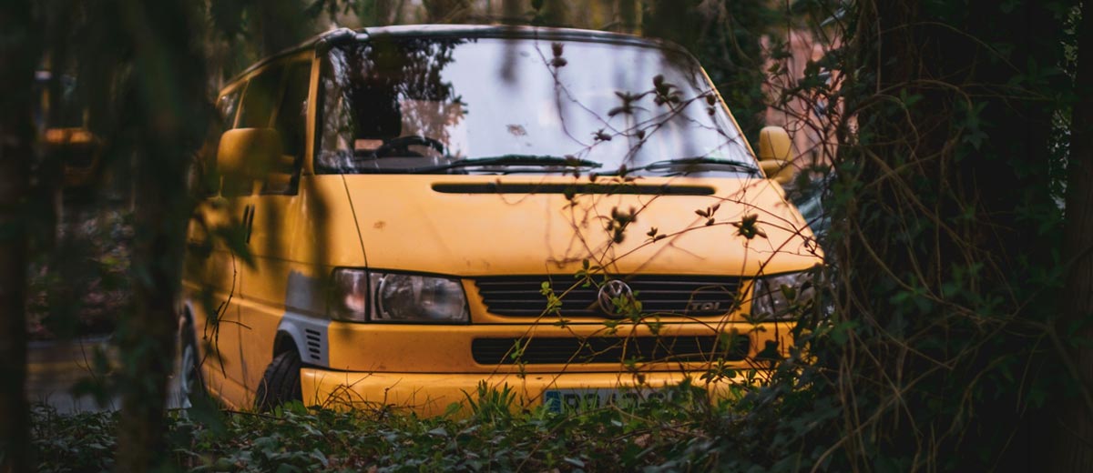 Yellow VW T4 through the trees