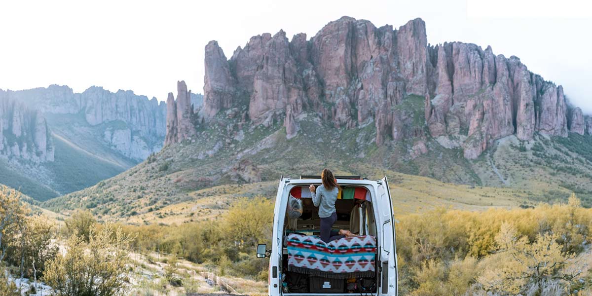 Person looking at the mountains from a campervan