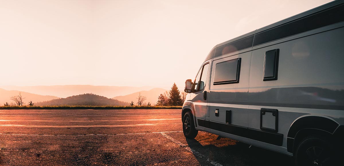 Campervan parked at the side of the road in the sunlight