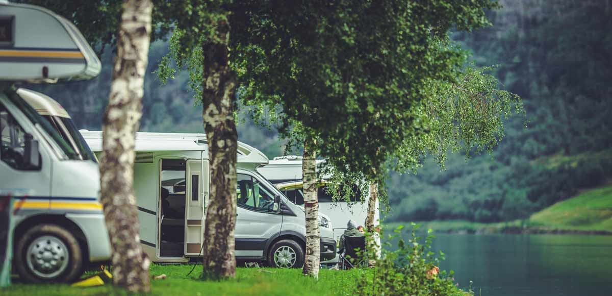 Motorhomes parked up by a lake