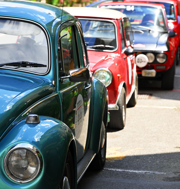 Various classic cars parked in a line